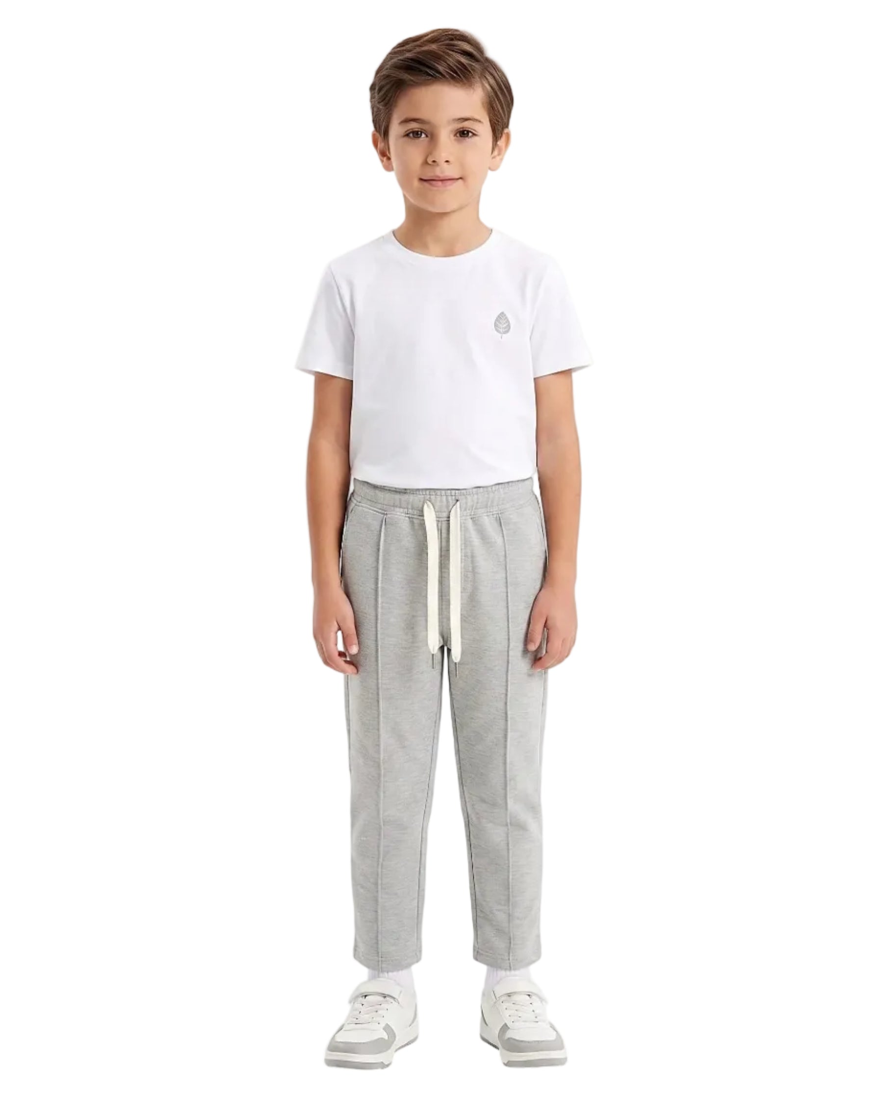 Front view of a boy wearing boys' summer grey milton pants featuring an elastic waist and drawstring tie by TREE.