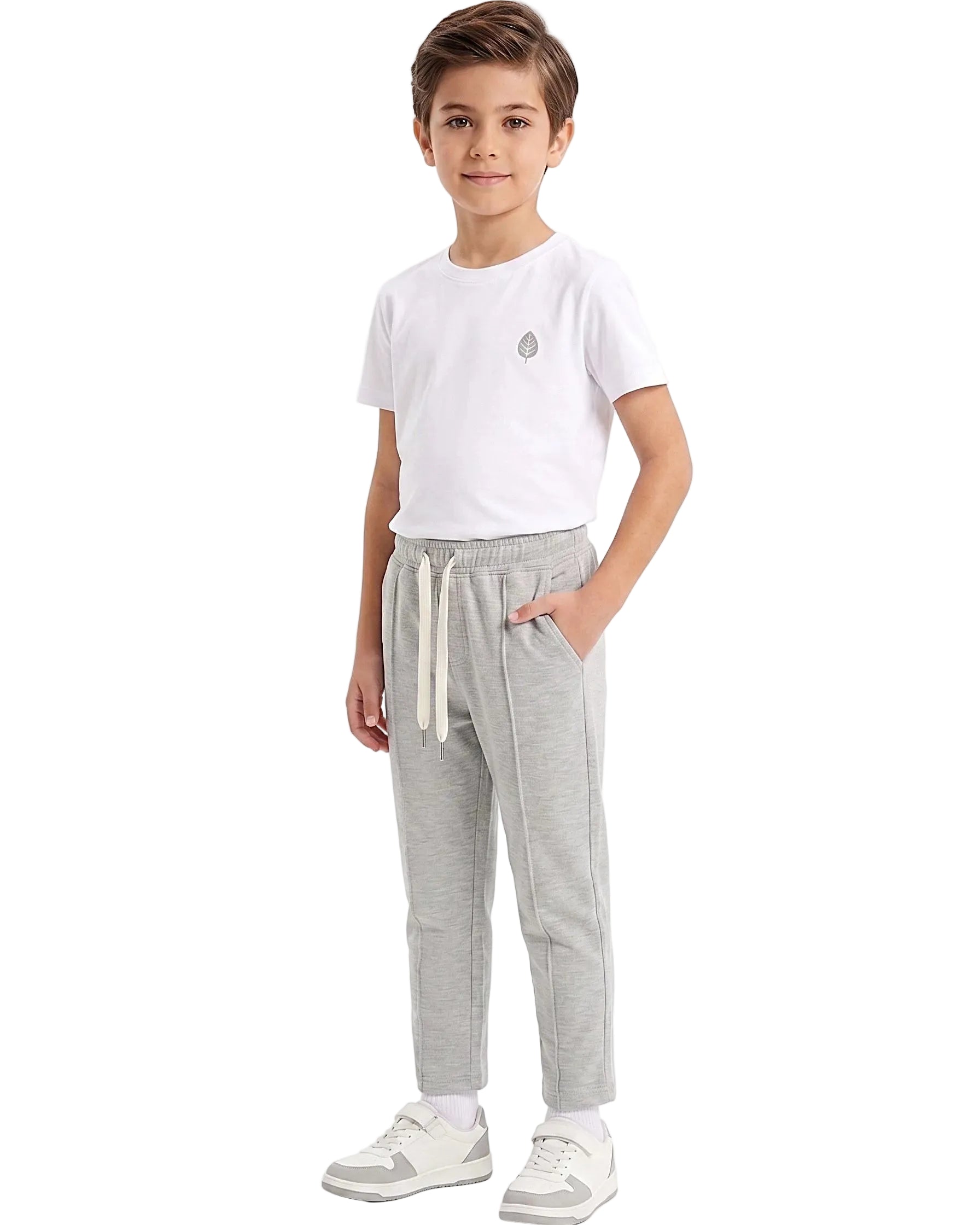 Front view of a boy wearing boys' summer grey milton pants featuring an elastic waist and drawstring tie by TREE.