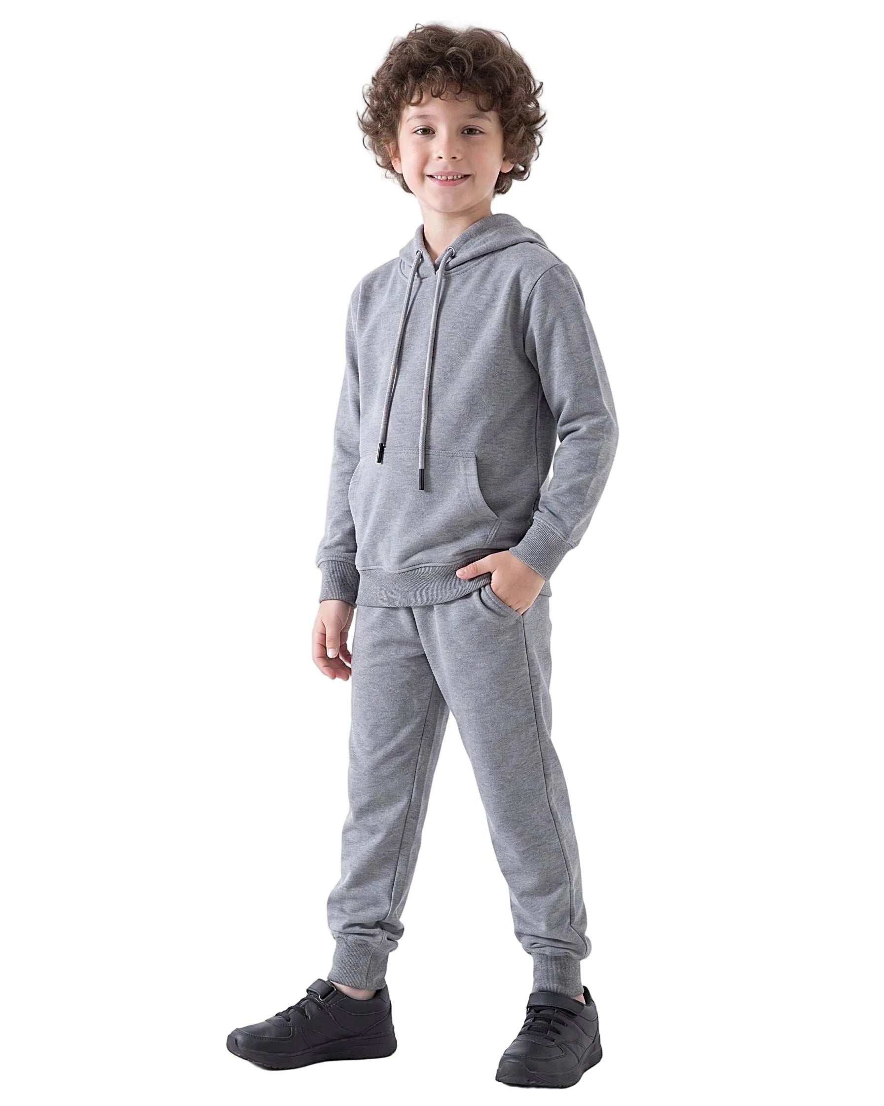 Full-body view of a boy modeling a Boys' Solid Grey Summer Milton Hoodie with one hand in the pocket, paired with matching sweatpants and black sneakers.