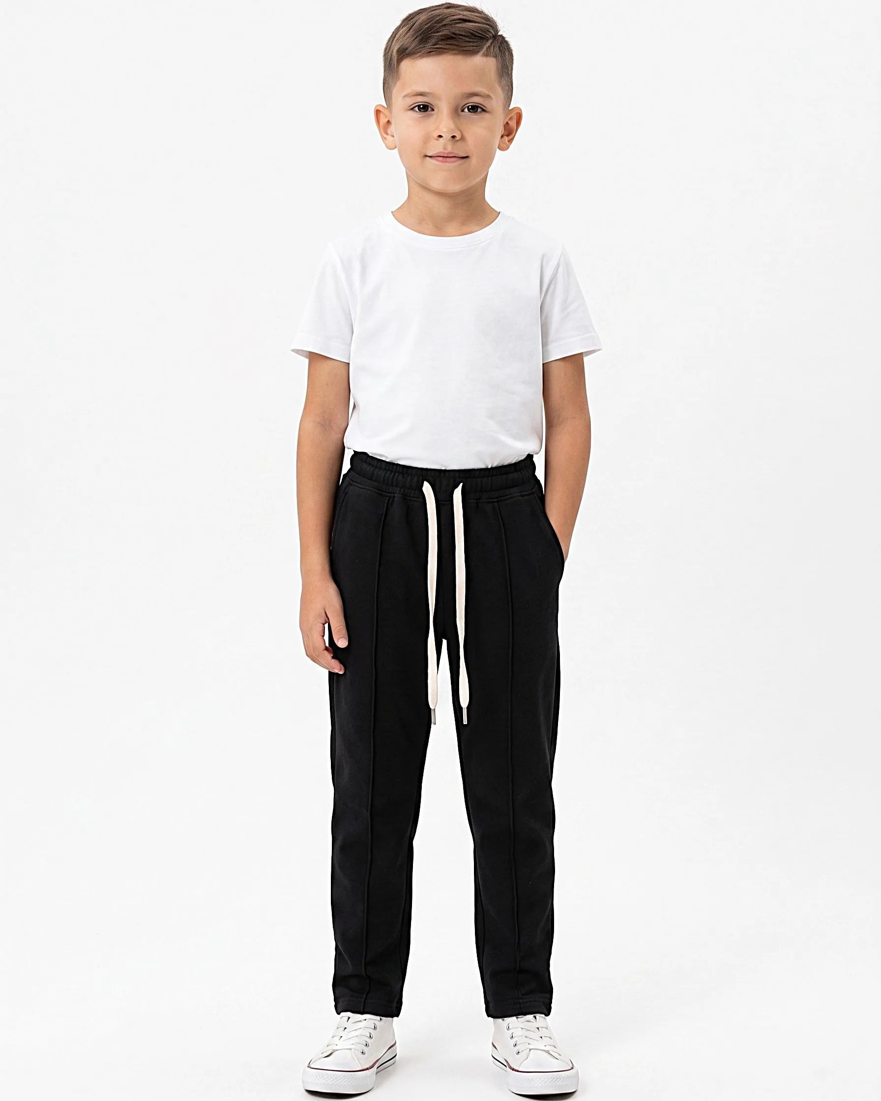 Front view of a boy wearing boys' sweatpants with an elastic waist by TREE.
