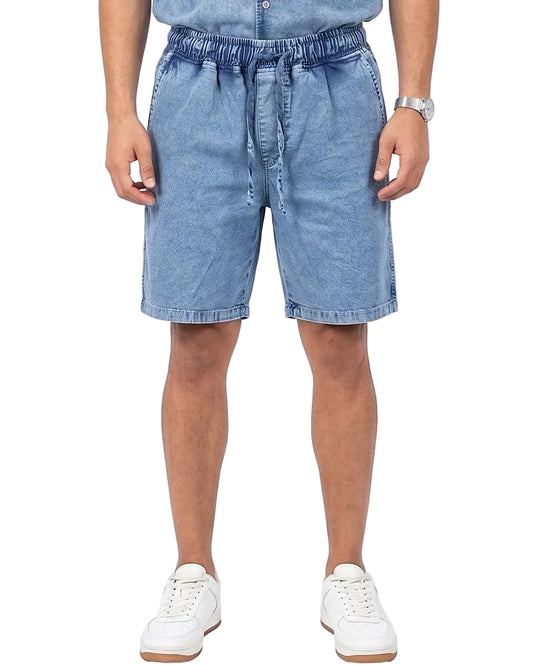 Front view of a model wearing men's 100% cotton denim shorts with an elastic waist by TREE.