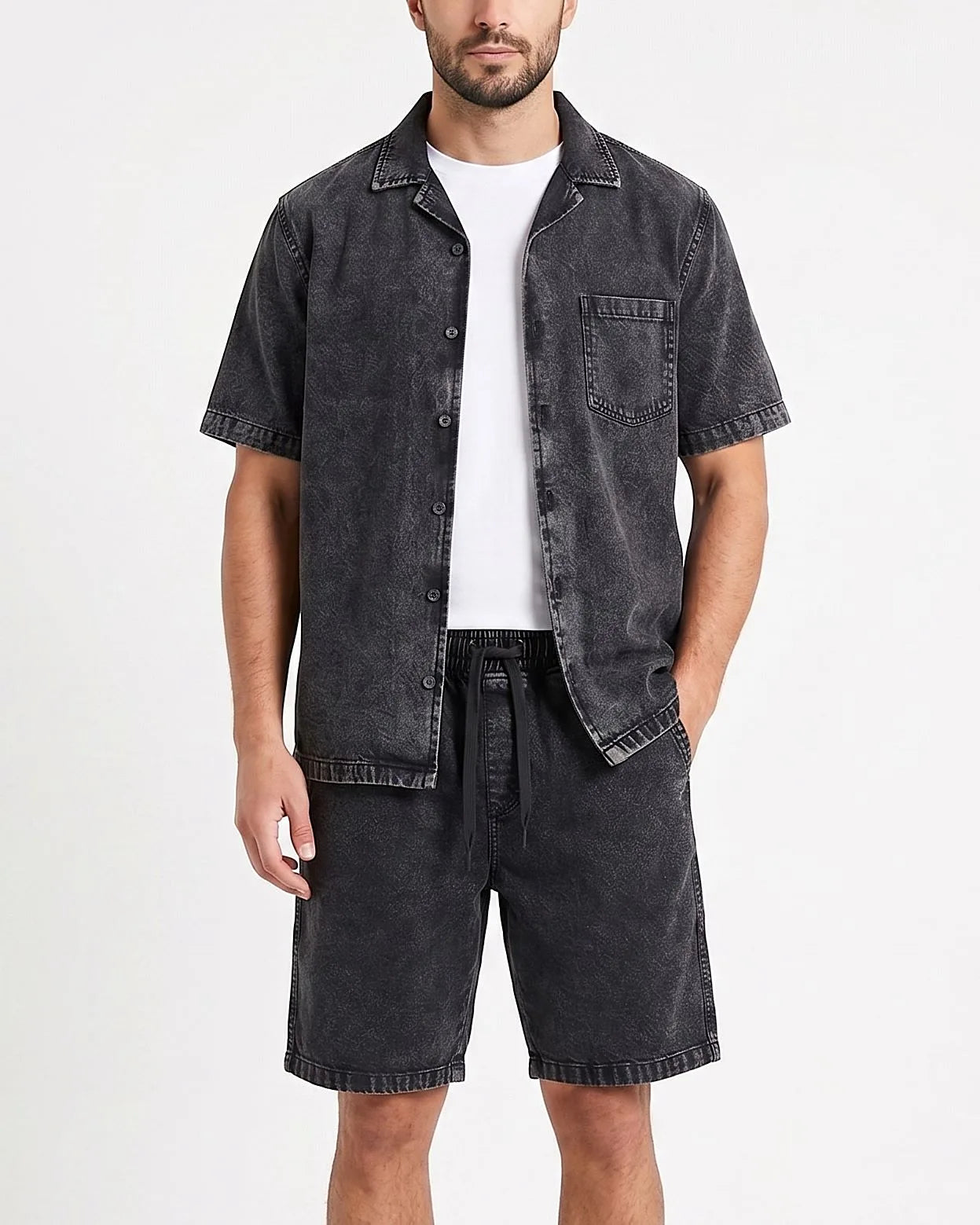 Front view of a model wearing men's 100% cotton denim shorts with an elastic waist by TREE.