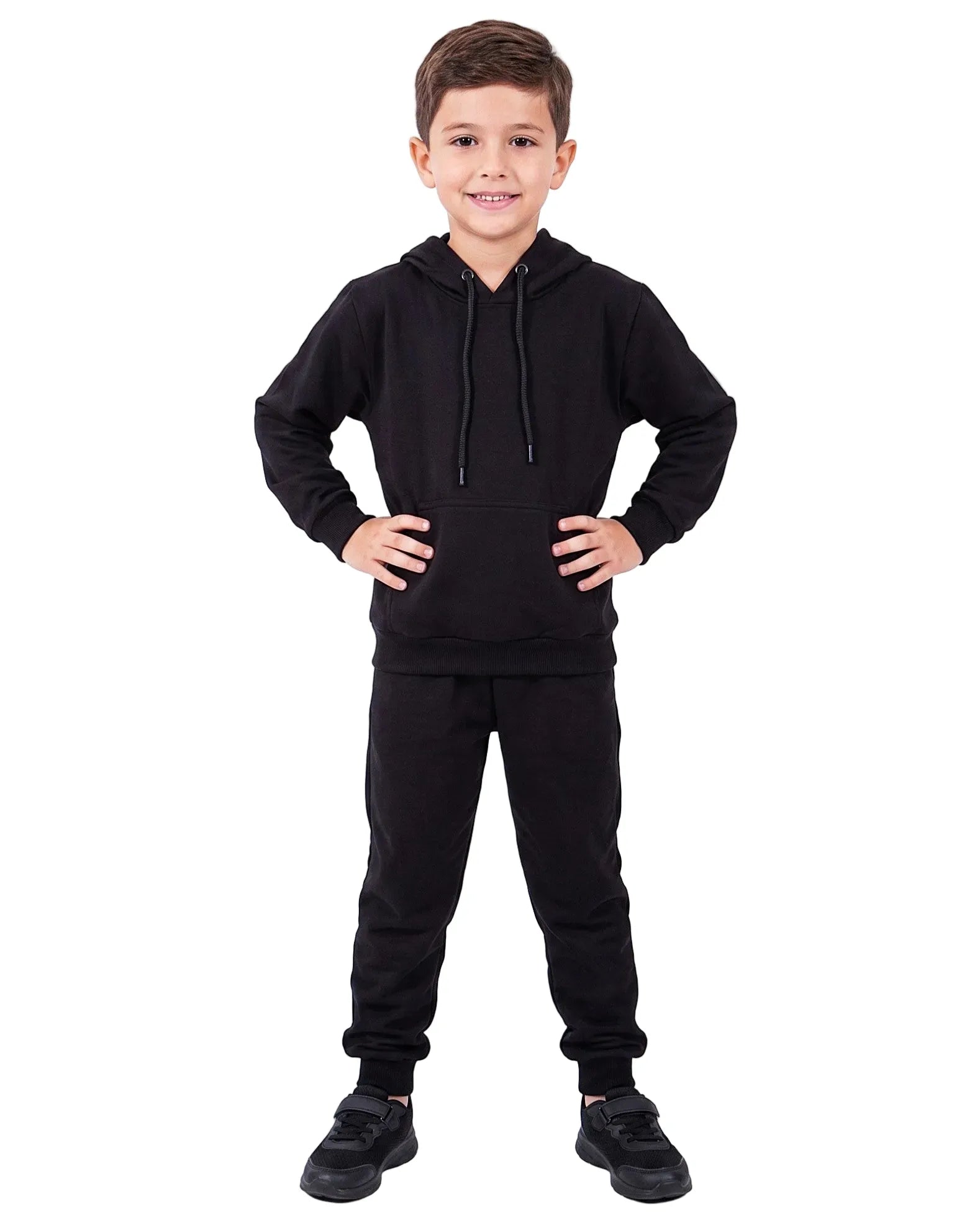 Front view of a boy wearing boys' black summer milton sweatpants (100% cotton) paired with a matching hoodie by TREE.