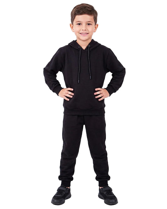 Front view of a boy wearing boys' black summer milton sweatpants (100% cotton) paired with a matching hoodie by TREE.