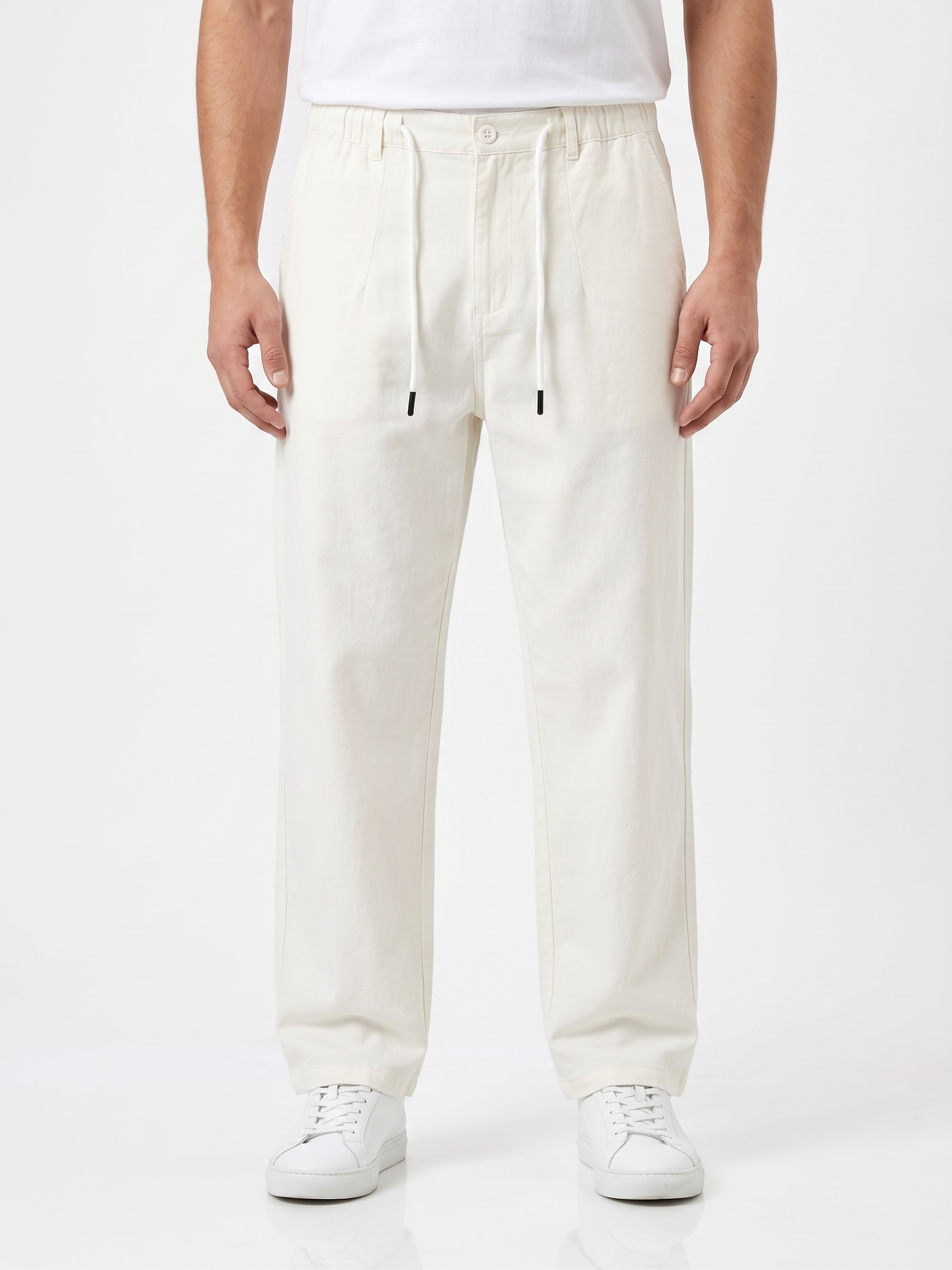 Person wearing white pants on a white background