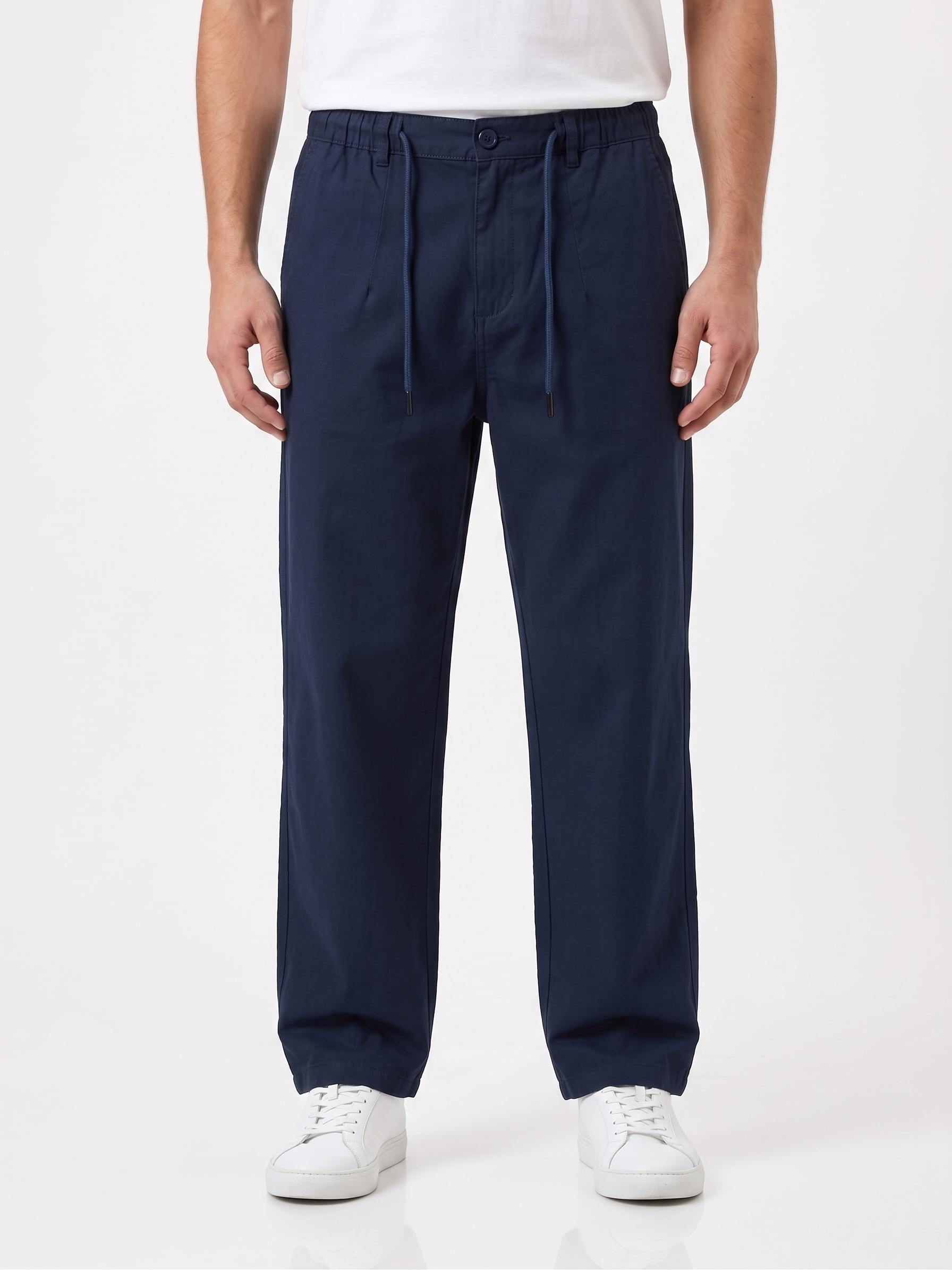 Navy blue pants worn by a person on a white background