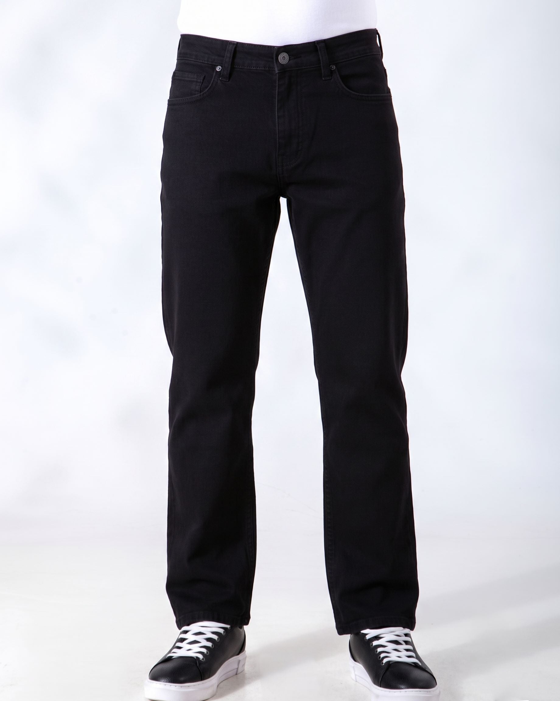 Black denim jeans shown on a cropped lower-body mannequin or model, paired with black sneakers against a plain light gray studio background.