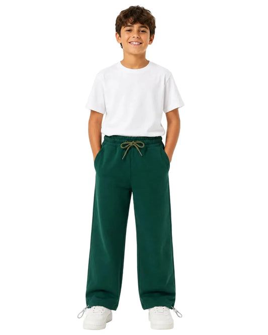 Multiple views of a boy wearing dark green summer milton wide-leg sweatpants with side pockets and a drawstring waist by TREE.