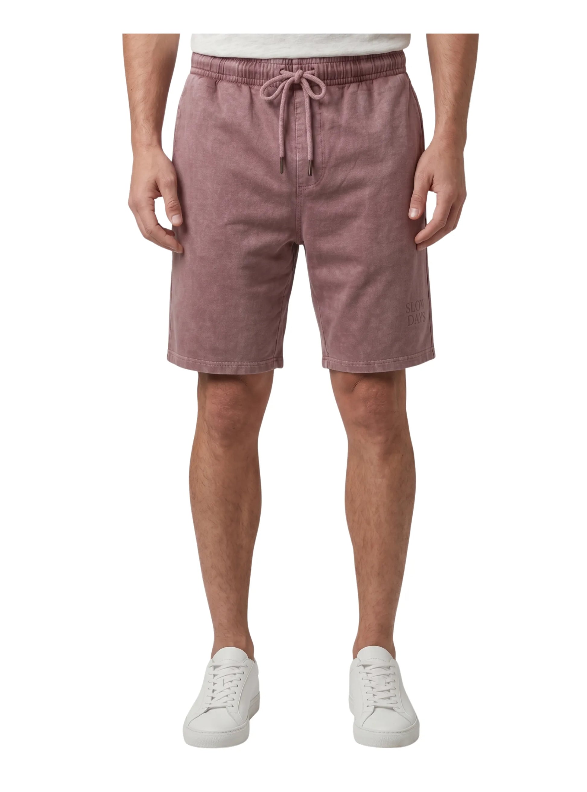 Front view of a man wearing faded burgundy casual summer shorts with an elastic drawstring waist by TREE