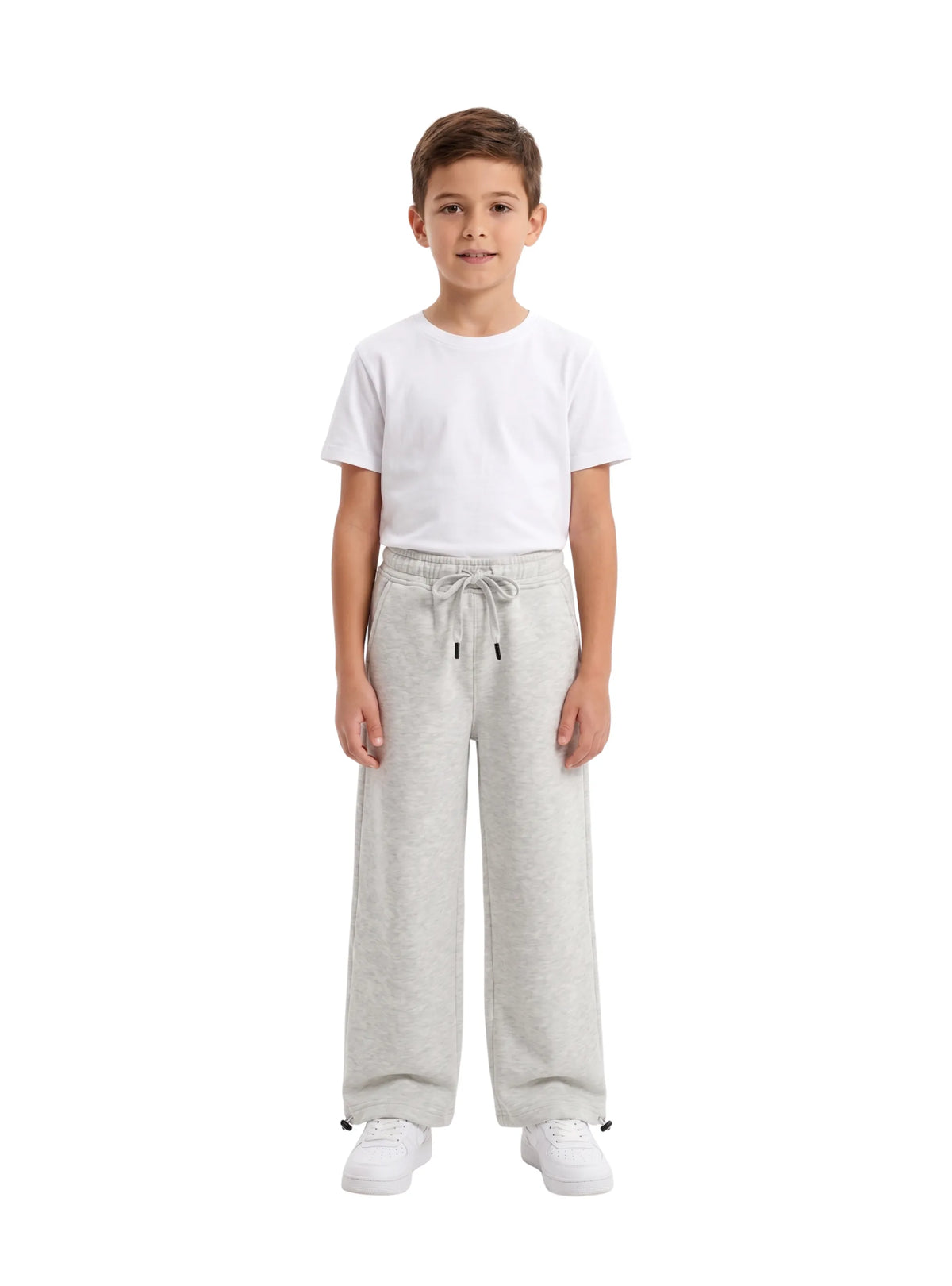 Full-length view of boy wearing TREE light grey relaxed wide-leg sweatpants and white t-shirt