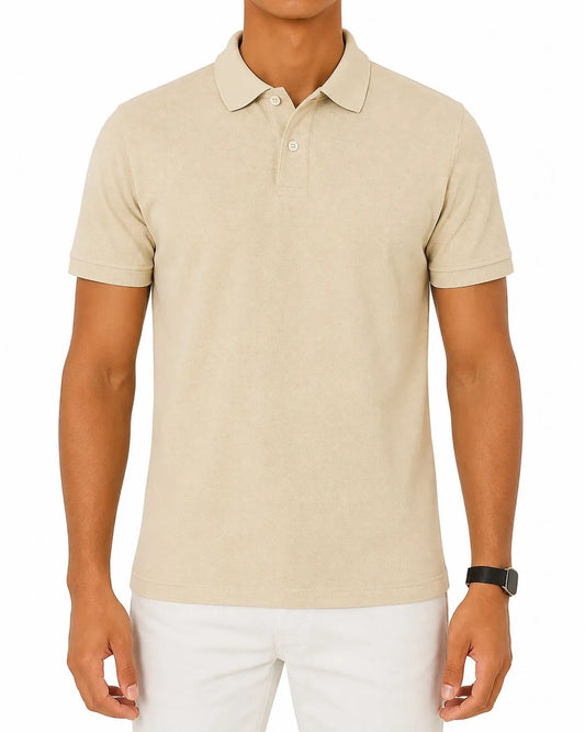Front view of a man wearing a beige piqué polo shirt featuring a regular fit by TREE.