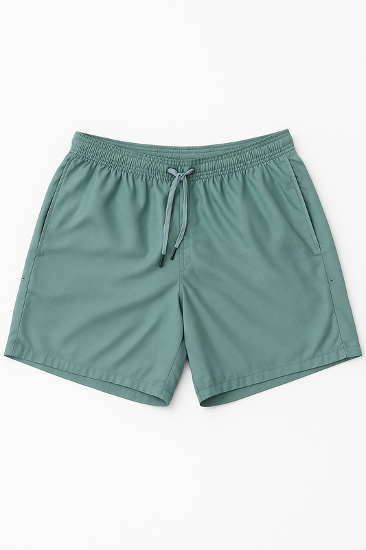 Green shorts with a drawstring on a white background