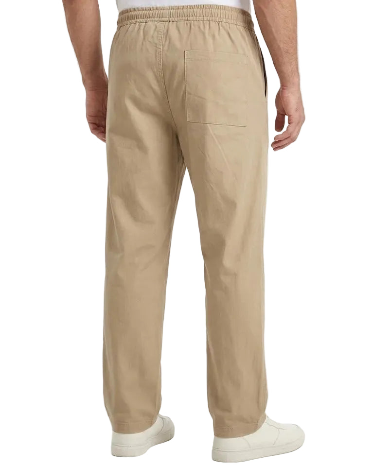 A man wearing beige drawstring trousers, viewed from the back, paired with a white t-shirt and white sneakers against a plain white background.