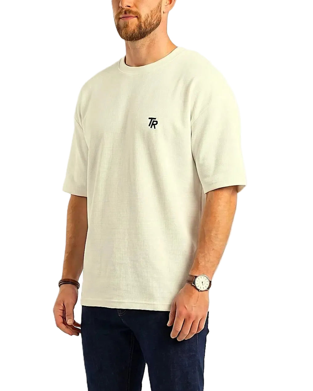 Fabric Detail Image: Close-up showing the visible cotton texture and the precise TR embroidery on the chest.
Sleeve Detail Image: Angle showing the relaxed oversized fit and drop shoulder design of the men's t-shirt.