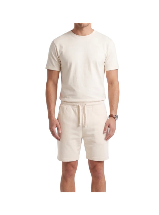 Front view of a man wearing a relaxed fit beige cotton short pajama set from TREE.