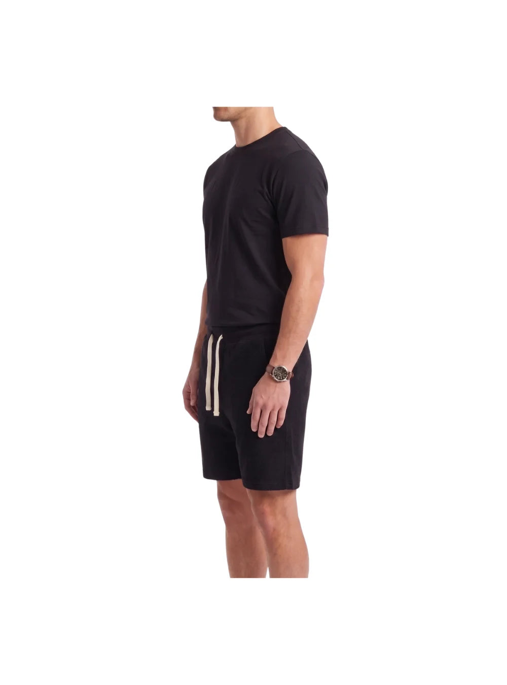 Man wearing a relaxed fit black cotton short pajama set from TREE, showing the back and fit details.