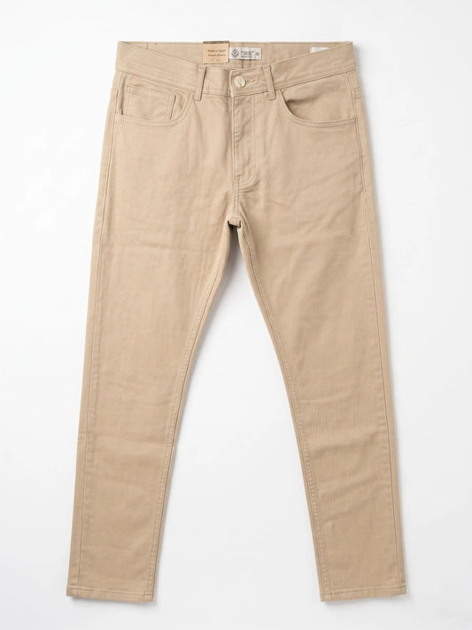 Studio shot of men's slim-fit 5-pocket gabardine pants in beige by TREE.