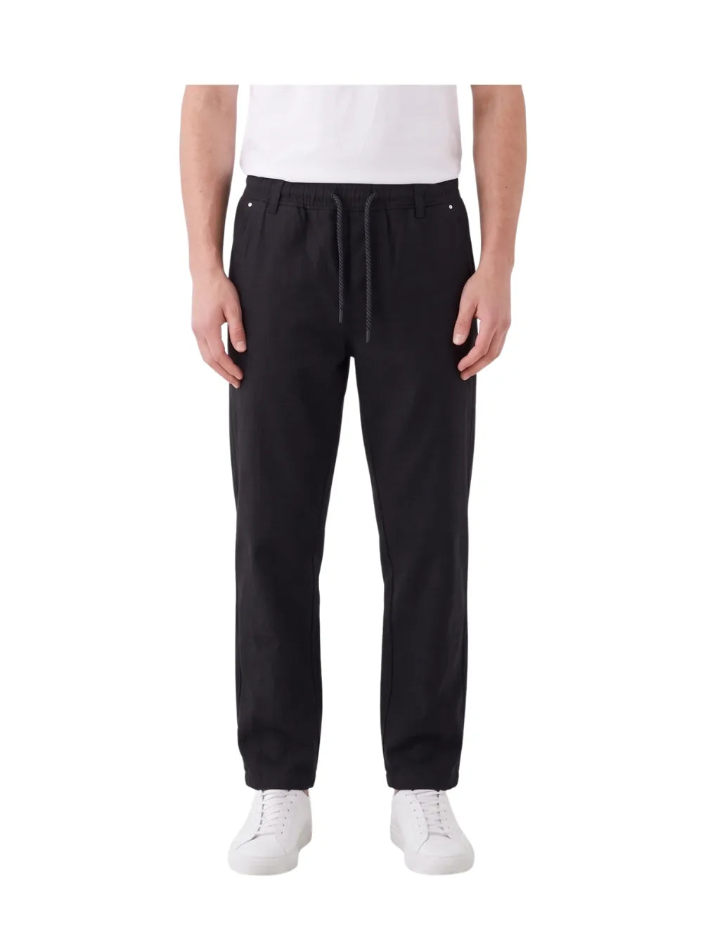 Front view of a man wearing black wide-leg gabardine sarouel pants by TREE