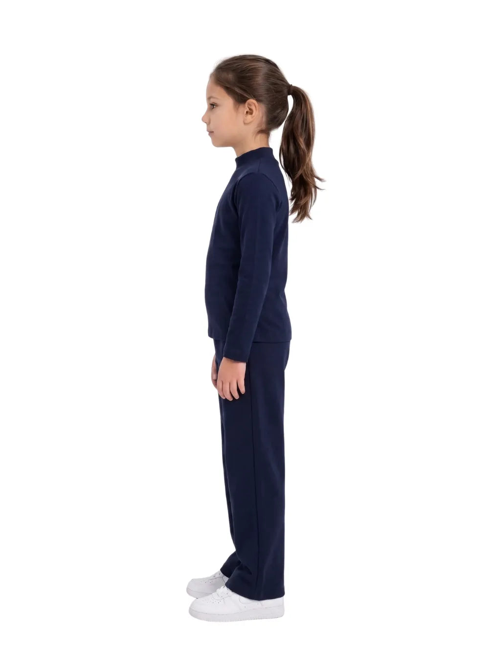 Side view of a young girl wearing a navy long-sleeve high-neck basic top by TREE.