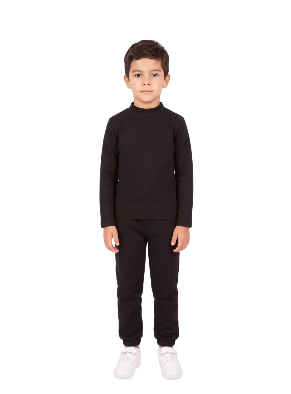 Front view of a young boy wearing a black long-sleeve high-neck basic top by TREE.