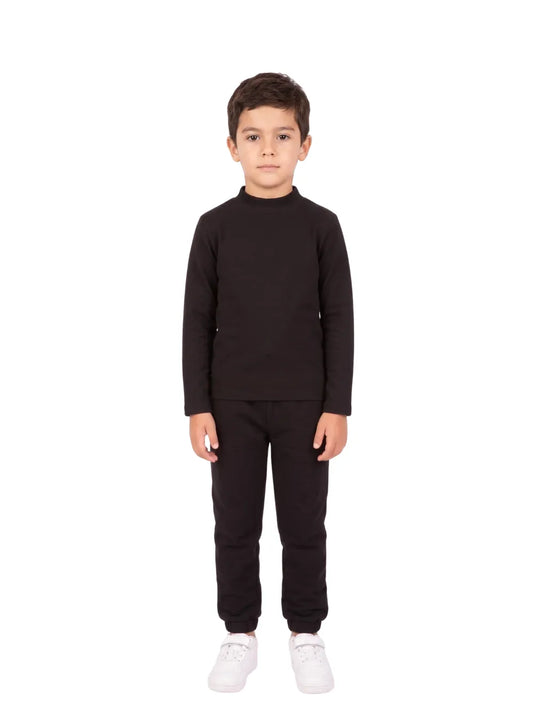 Front view of a young boy wearing a black long-sleeve high-neck basic top by TREE.