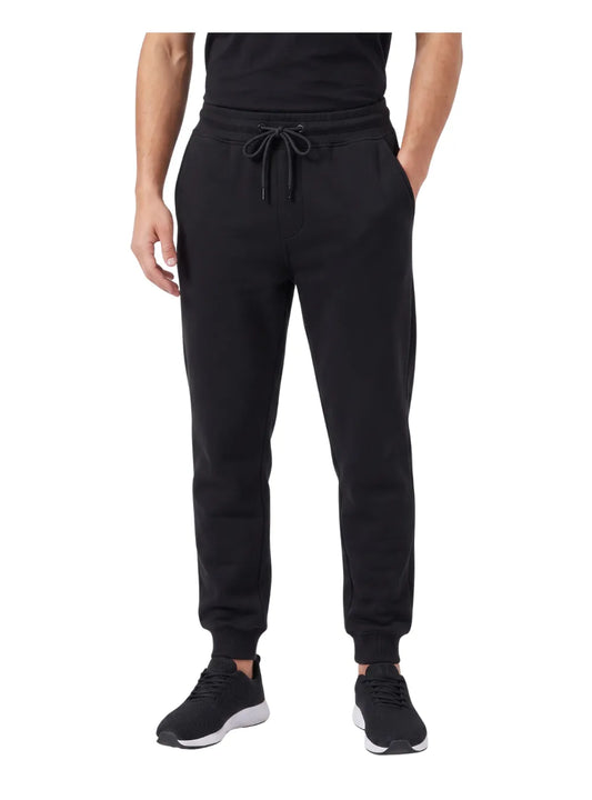 Front view of a man wearing heavy winter milton sweatpants in black by TREE