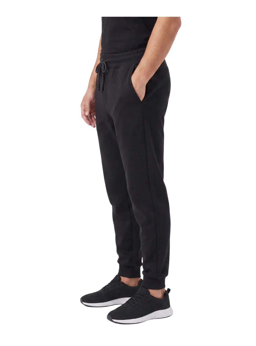 Front view of a man wearing heavy winter milton sweatpants in black by TREE
