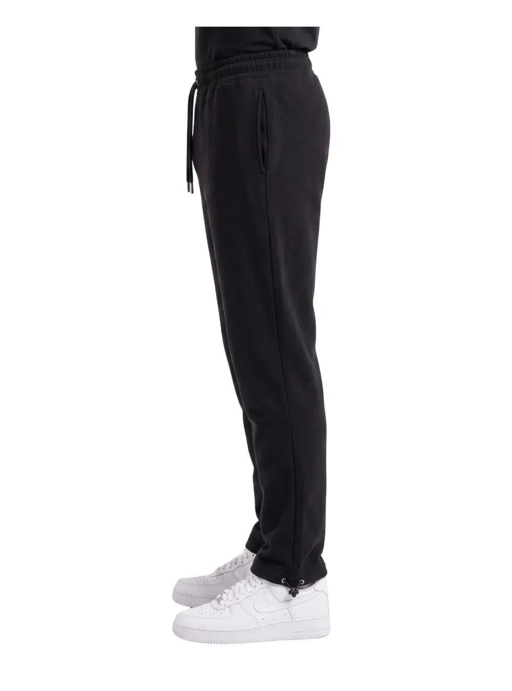Front view of a man wearing wide-leg sweatpants in black by TREE.