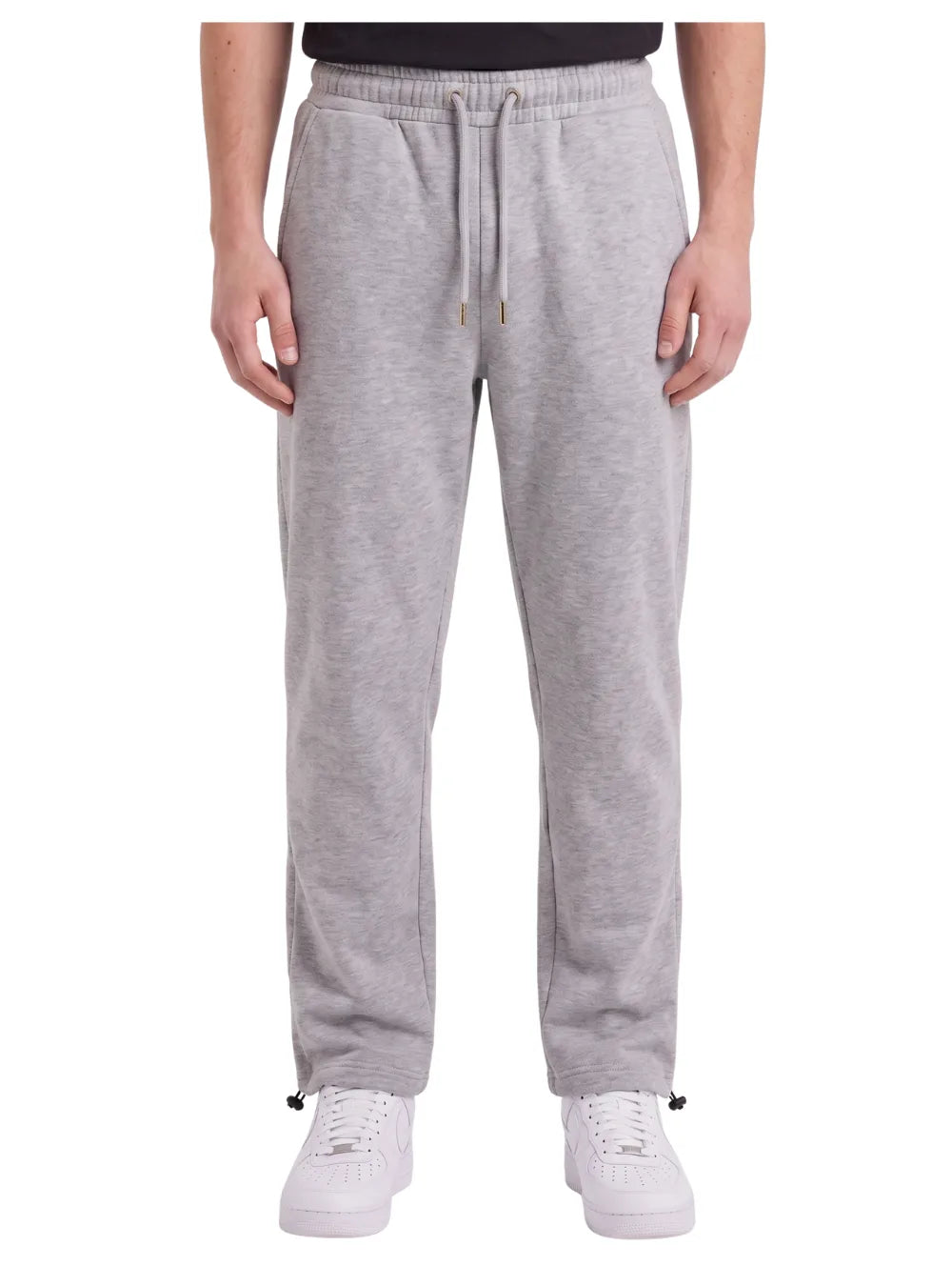 Front view of a man wearing wide-leg sweatpants in gray by TREE.