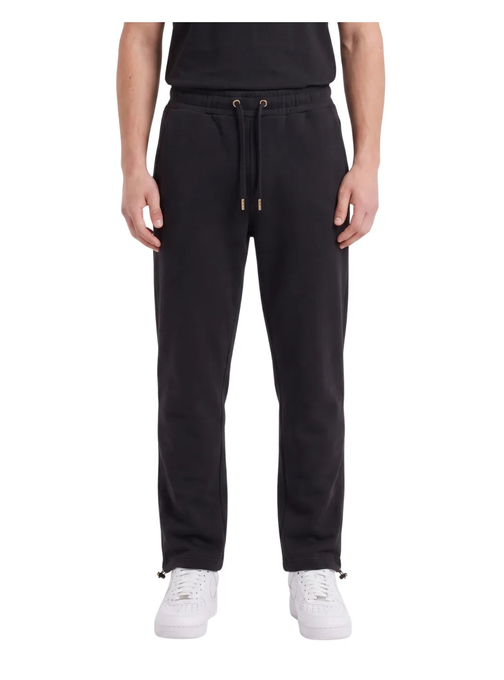 Front view of a man wearing wide-leg sweatpants in black by TREE.