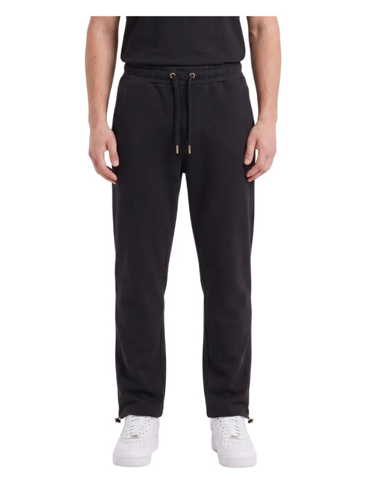 Front view of a man wearing wide-leg sweatpants in black by TREE.