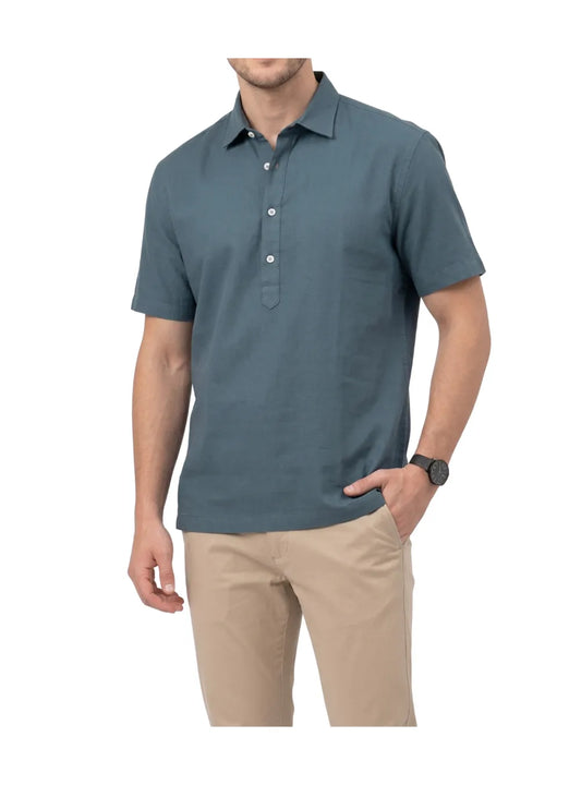 Front view of a man wearing a casual petrol half-button textured shirt by TREE.