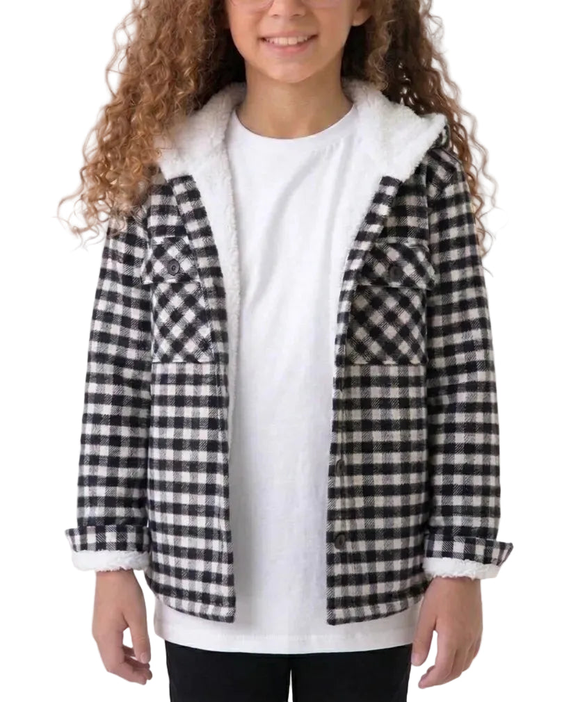 A child wearing a black and white buffalo check flannel jacket with a white sherpa-lined hood and collar, layered over a white t-shirt.