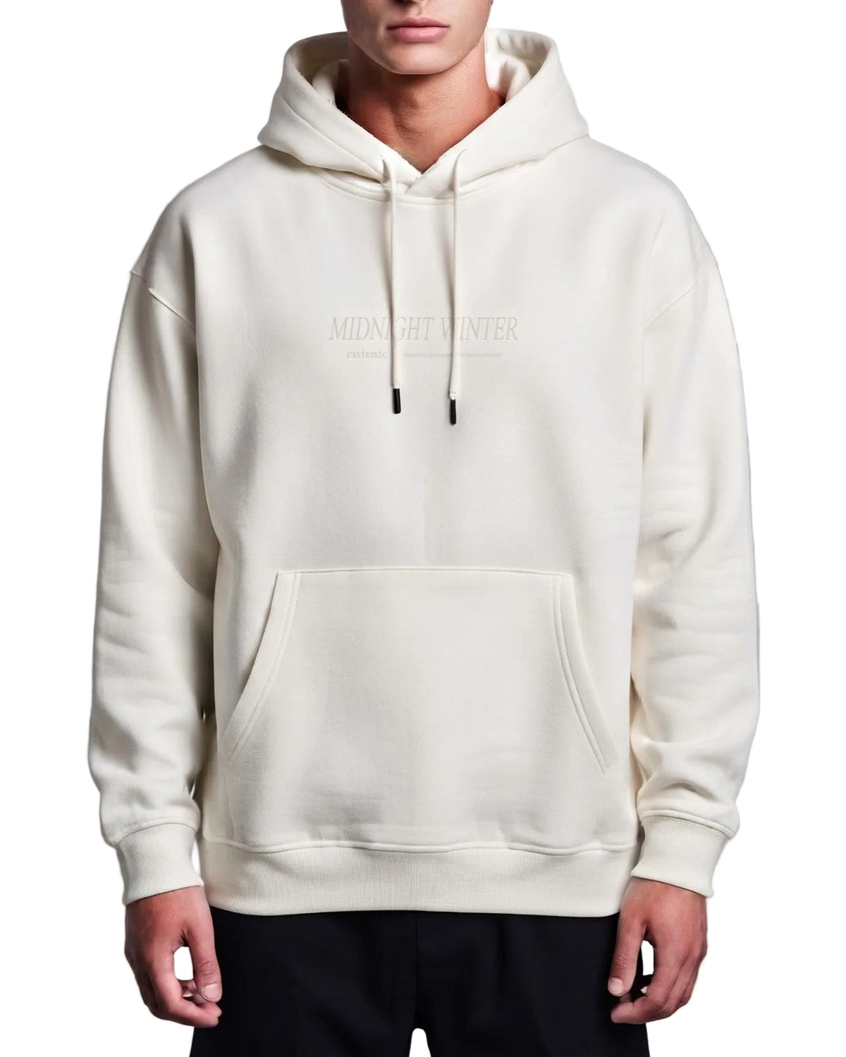 A man wearing a cream-colored pullover hoodie with a drawstring hood and a kangaroo pocket, featuring a subtle 'MIDNIGHT WINTER' text graphic on the chest, set against a plain gray studio background.