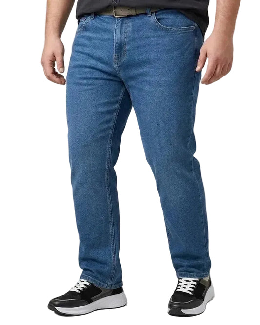 A person wearing medium-wash blue jeans, a dark gray shirt, and black sneakers, shown from the waist down against a light gray studio background.