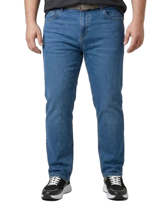 A person wearing medium blue straight-leg denim jeans, a dark gray shirt, and black sneakers, shown from the waist down against a light gray studio background.
