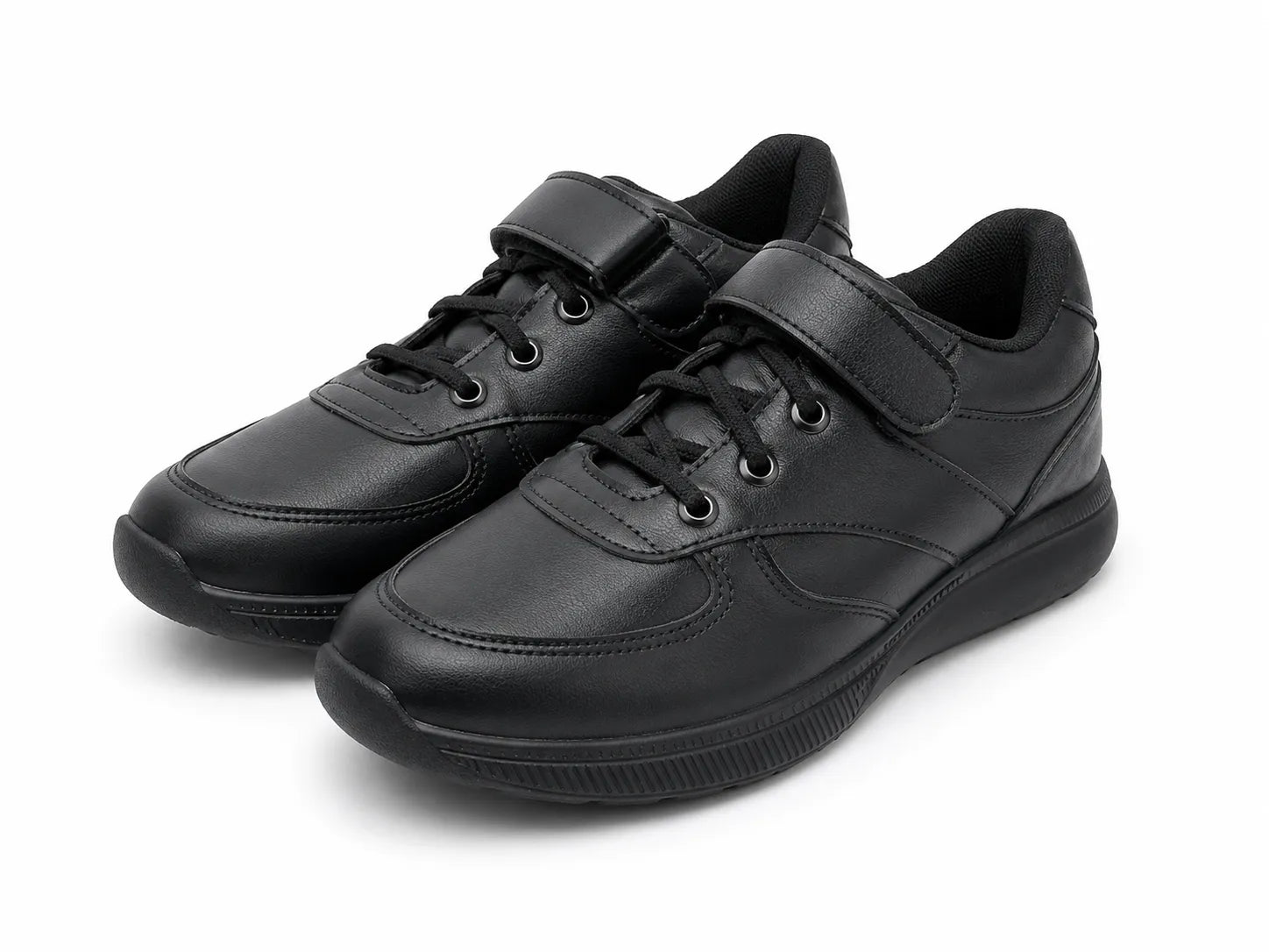 Boys' solid black casual sneakers with visible texture and velcro strap from TREE