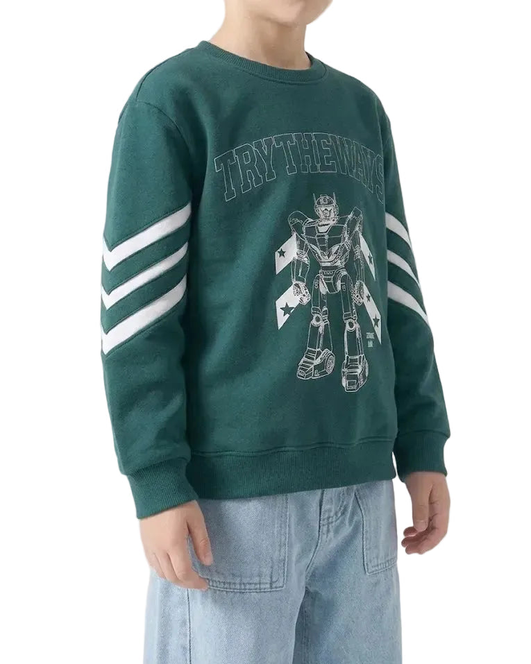 A child wearing a dark green crewneck sweatshirt with white graphic prints on the front and white stripes on the sleeves, paired with light blue jeans, against a plain white background.
