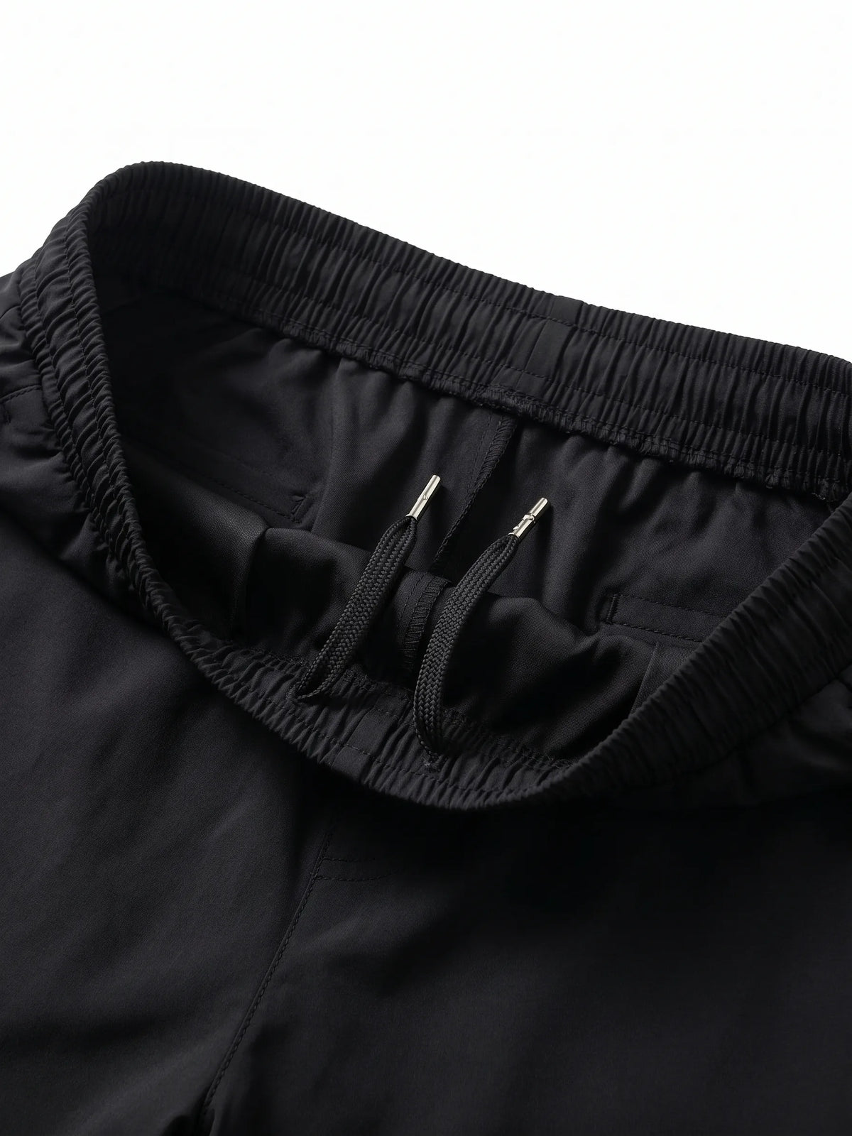 Close-up fabric texture and waistband details of men's black polyester sweatpants from TREE