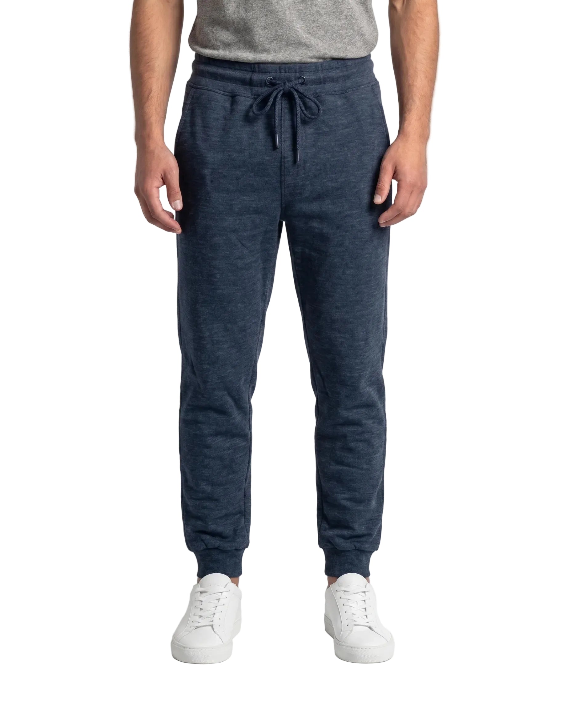 Front view of a man wearing navy slim fit sweatpants by TREE.