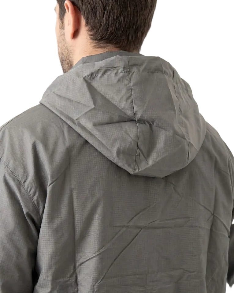 Rear view of a man wearing a gray hooded jacket against a plain white background.