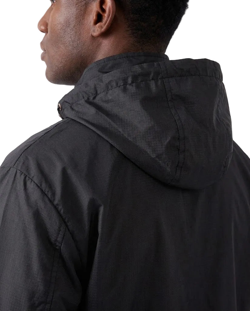 Close-up back view of a person wearing a black hooded jacket against a plain light background.