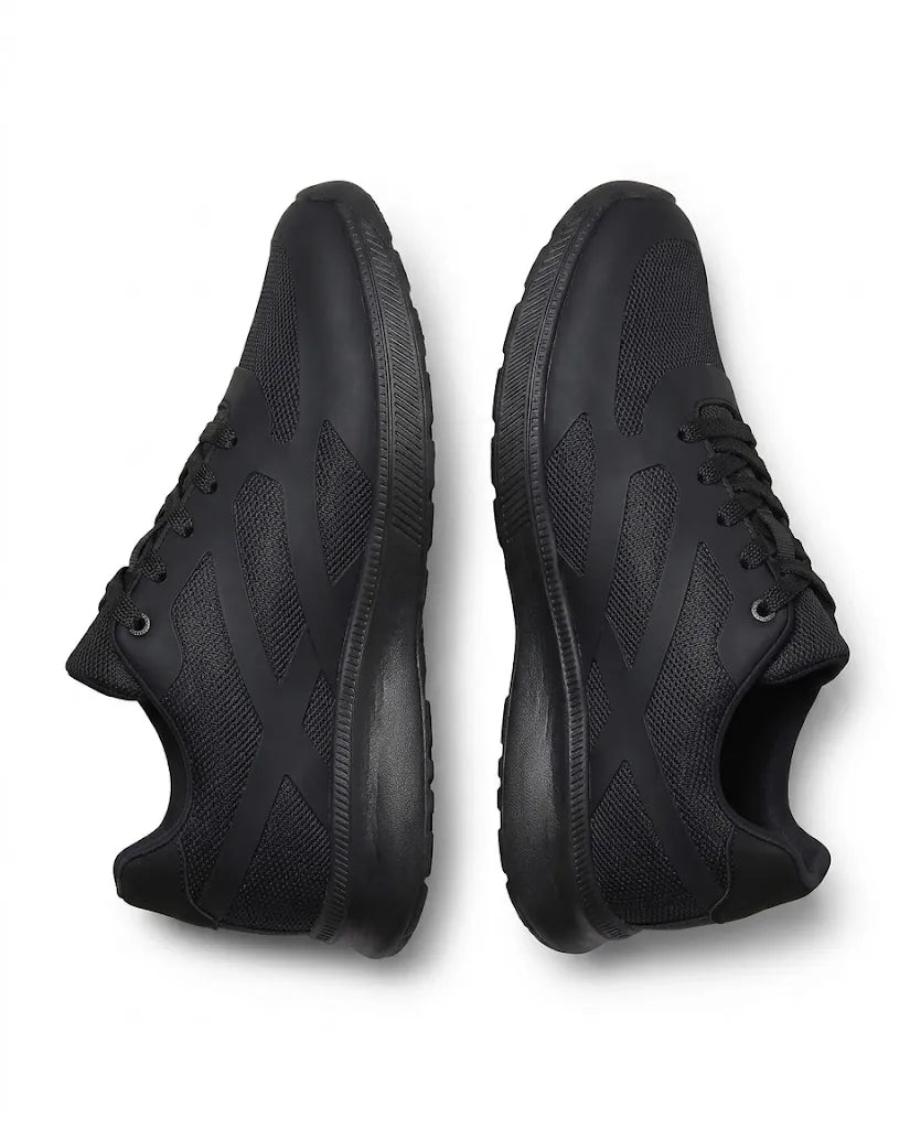 Side profile of TREE's youth black athletic sneakers showcasing the mesh texture
