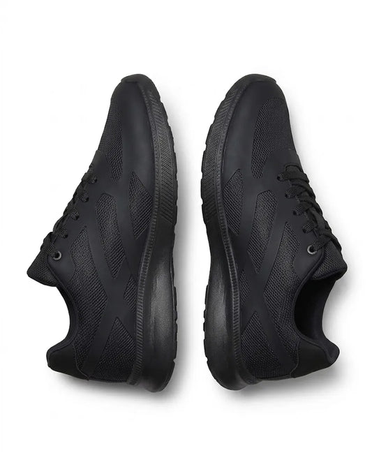 Side profile of TREE's youth black athletic sneakers showcasing the mesh texture