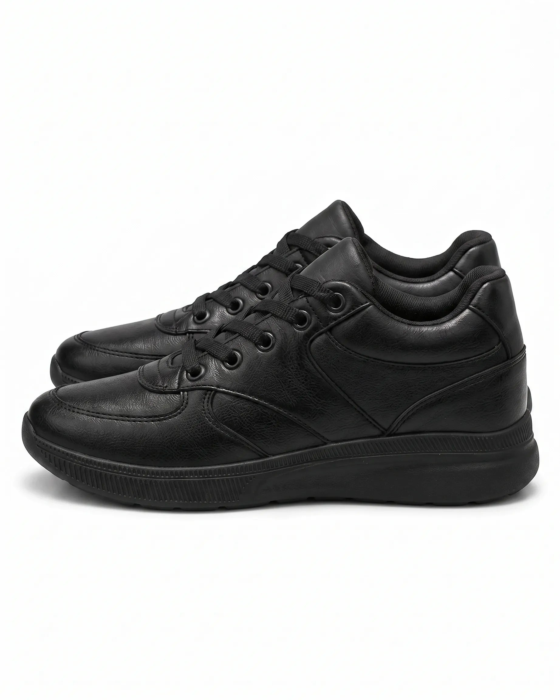 Side profile of TREE's black casual sneakers showing panel stitching and sole details