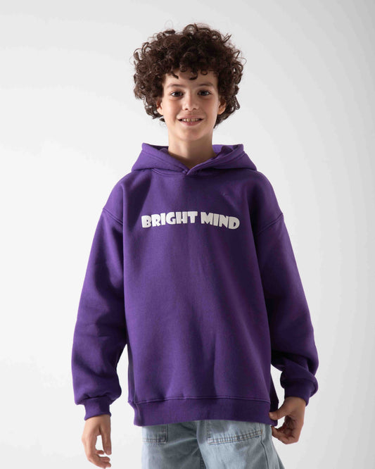 Child wearing a purple hoodie with 'BRIGHT MIND' text on a white background