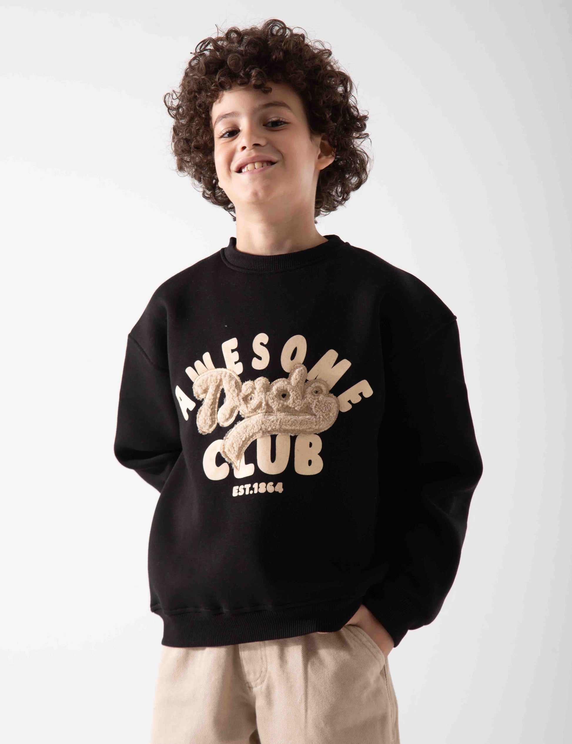 Child wearing a black sweatshirt with 'Dudes Club' text on a white background
