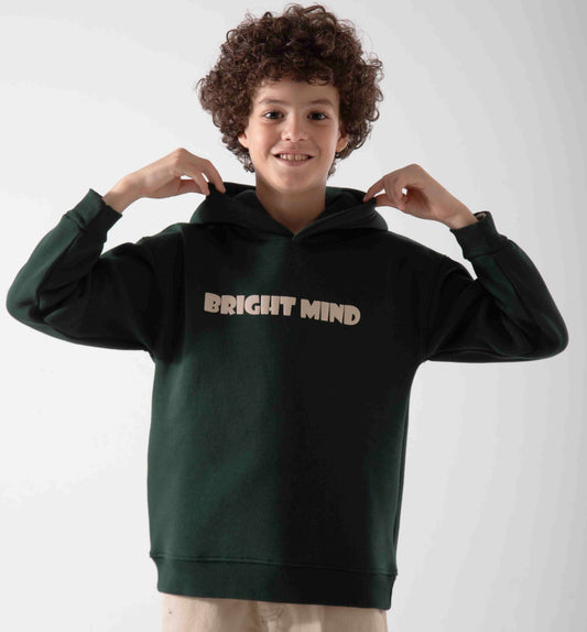 Child wearing a dark green hoodie with 'BRIGHT MIND' text on a plain background
