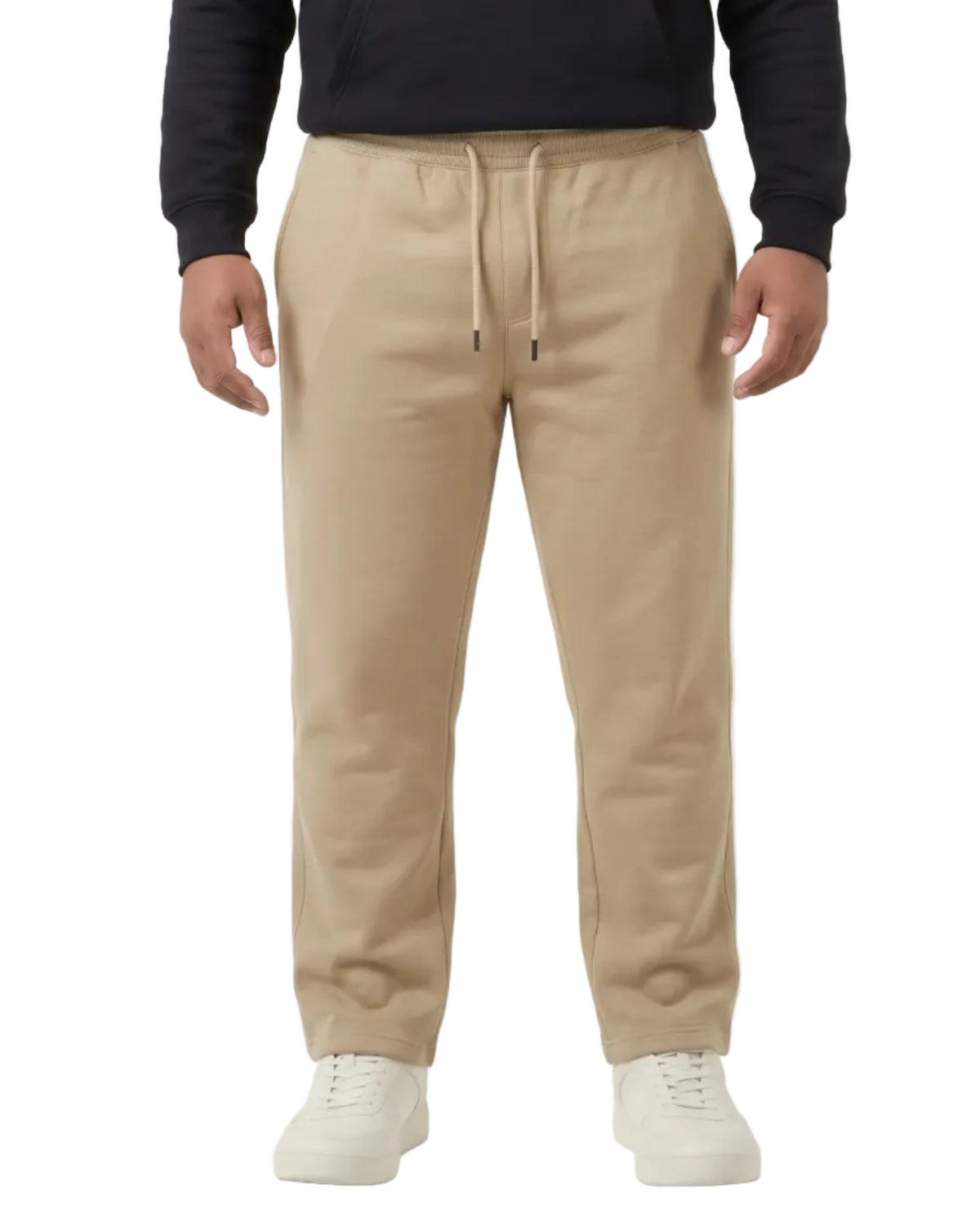A model wearing a black cropped hoodie with 'FREEDOM' in white and blue text, paired with beige drawstring sweatpants and white sneakers, against a plain white studio background.