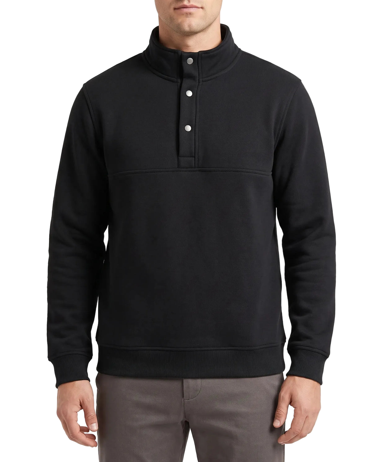 A man wearing a black long-sleeve mock neck pullover sweatshirt with a three-button placket, paired with gray trousers, against a plain white background.
